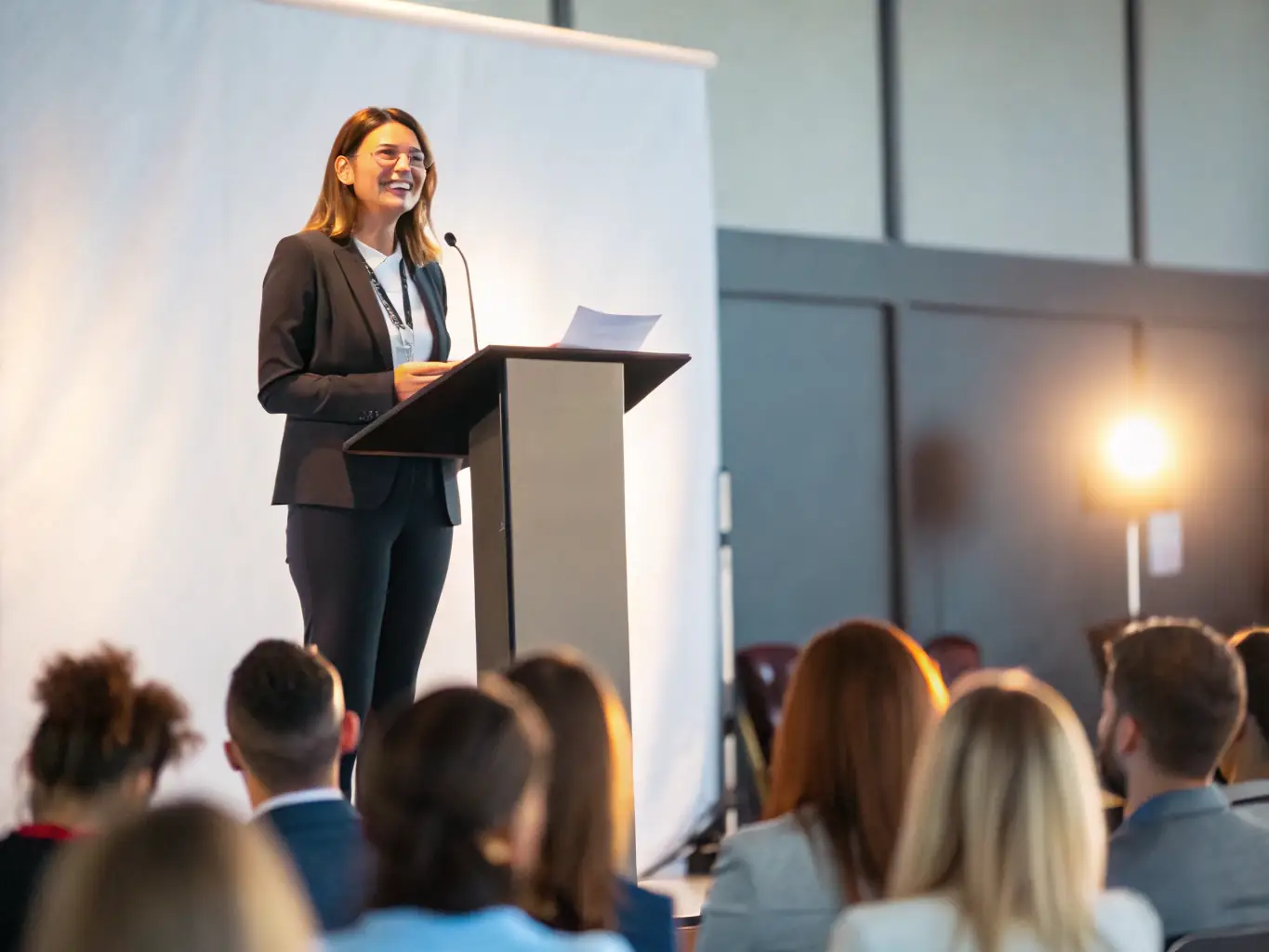 A confident speaker is shown delivering a compelling presentation to a large audience, demonstrating the art of persuasive communication and the ability to captivate and inspire others.